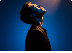 Person looking upward in blue light